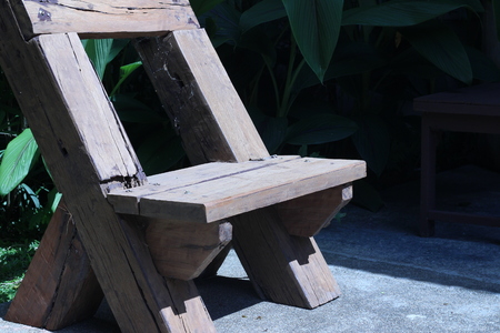 rown wooden bench placed in the backyardの写真素材