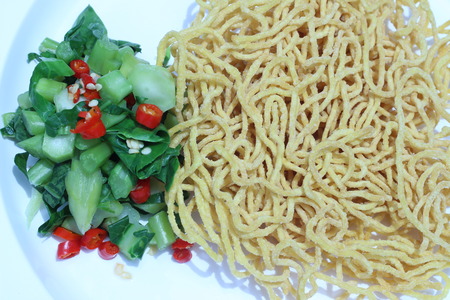 Kale noodles topped with pork and red pepperの写真素材