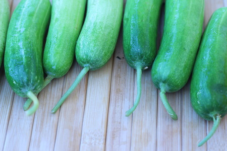 Fresh vegetables placed together on a brown backgroundの写真素材