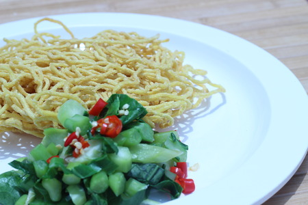 Kale noodles topped with pork and red pepperの写真素材