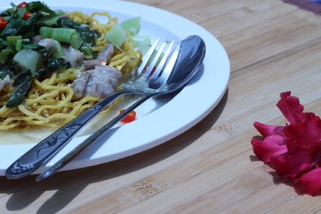 Kale noodles topped with pork and red pepperの写真素材