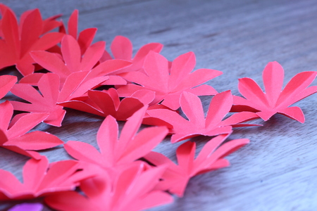 Many colorful paper flowers on a background with a smooth surfaceの写真素材