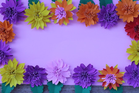 Many colorful paper flowers on a background with a smooth surfaceの写真素材