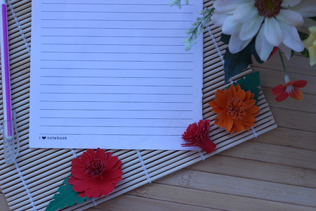 Writing paper and pen placed on a wooden brown backgroundの写真素材