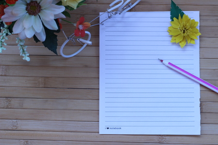 Writing paper and pen placed on a wooden brown backgroundの写真素材