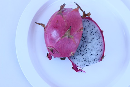 The red dragon fruits in white plate pretty appealingの写真素材