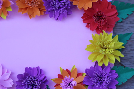 Many colorful paper flowers on a background with a smooth surfaceの写真素材