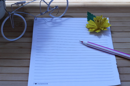 Writing paper and pen placed on a wooden brown backgroundの写真素材