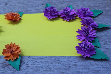 Many colorful paper flowers on a background with a smooth surfaceの写真素材