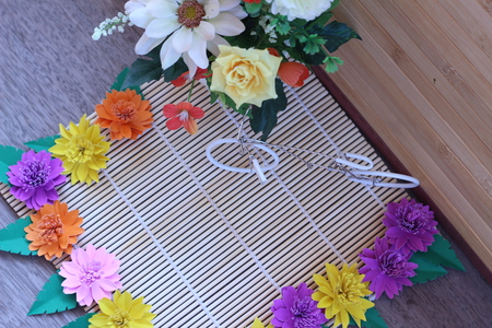 Many colorful paper flowers on a background with a smooth surfaceの写真素材