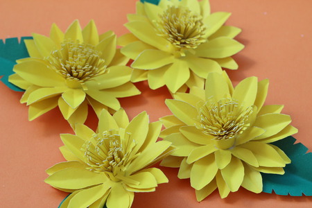Many colorful paper flowers on a background with a smooth surfaceの写真素材