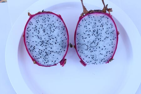 The red dragon fruits in white plate pretty appealingの写真素材