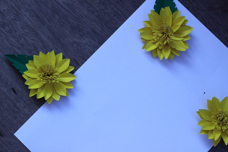 Many colorful paper flowers on a background with a smooth surfaceの写真素材