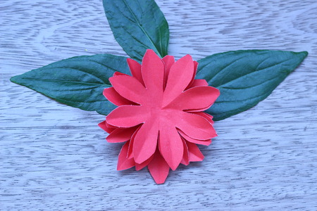Many colorful paper flowers on a background with a smooth surfaceの写真素材