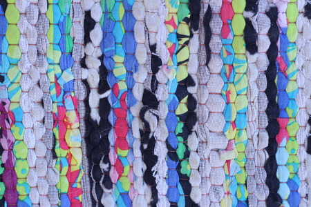 Fabrics woven by hand with beautiful colors on the old brown wooden plate