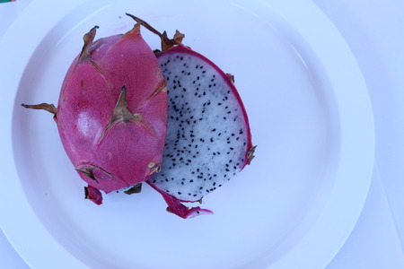 The red dragon fruits in white plate pretty appealingの写真素材