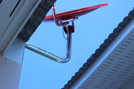 Cable TV dish installed on the roof of the Red Houseの写真素材