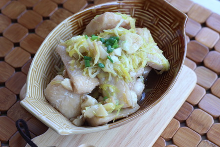 Fish in a bowl of soy sauce on brown.の写真素材