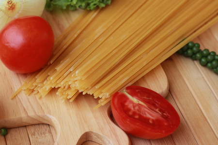 Spaghetti in a white plate and sliced sugar with red ketchupの写真素材