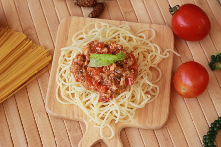 Spaghetti in a white plate and sliced sugar with red ketchupの写真素材