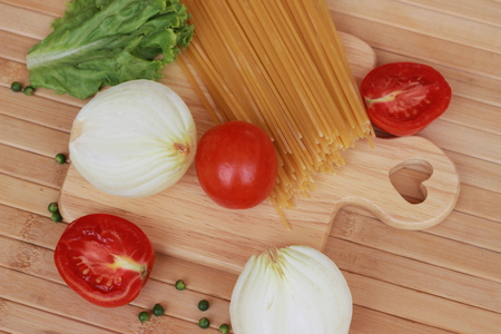 Spaghetti in a white plate and sliced sugar with red ketchupの写真素材