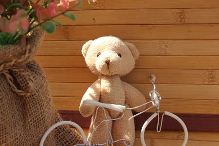 Cute brown bear doll on brown backgroundの写真素材