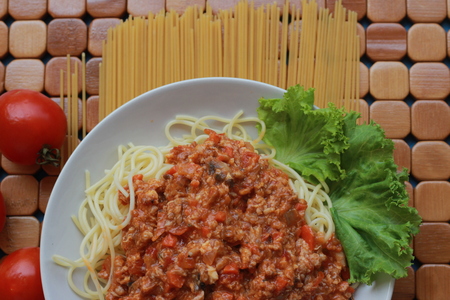 Spaghetti in a white plate and sliced sugar with red ketchupの写真素材