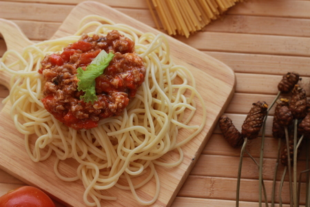 Spaghetti in a white plate and sliced sugar with red ketchupの写真素材