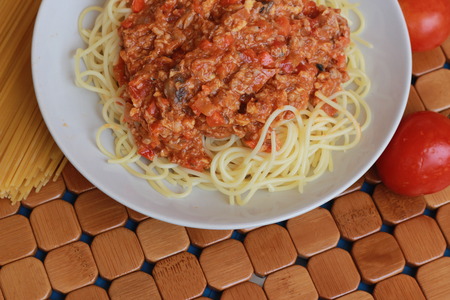 Spaghetti in a white plate and sliced sugar with red ketchupの写真素材