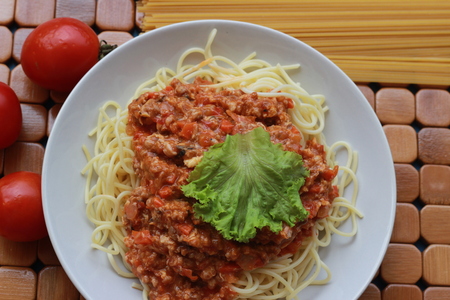 Spaghetti in a white plate and sliced sugar with red ketchupの写真素材