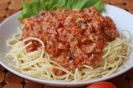 Spaghetti in a white plate and sliced sugar with red ketchupの写真素材