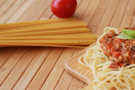 Spaghetti in a white plate and sliced sugar with red ketchupの写真素材