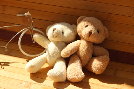 Cute brown bear doll on brown backgroundの写真素材