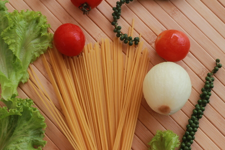 Spaghetti in a white plate and sliced sugar with red ketchupの写真素材