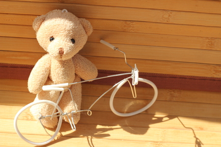 Cute brown bear doll on brown backgroundの写真素材