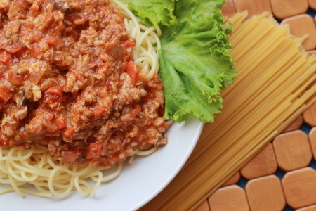Spaghetti in a white plate and sliced sugar with red ketchupの写真素材