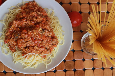 Spaghetti in a white plate and sliced sugar with red ketchupの写真素材