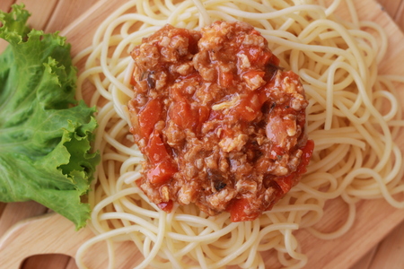 Spaghetti in a white plate and sliced sugar with red ketchupの写真素材