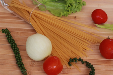 Spaghetti in a white plate and sliced sugar with red ketchupの写真素材