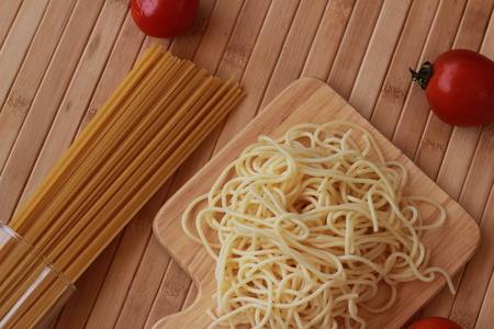 Spaghetti in a white plate and sliced sugar with red ketchupの写真素材