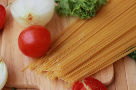 Spaghetti in a white plate and sliced sugar with red ketchupの写真素材