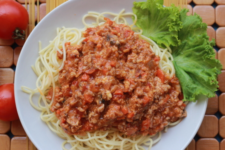 Spaghetti in a white plate and sliced sugar with red ketchupの写真素材