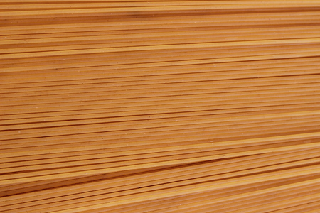 Spaghetti in a white plate and sliced sugar with red ketchupの写真素材