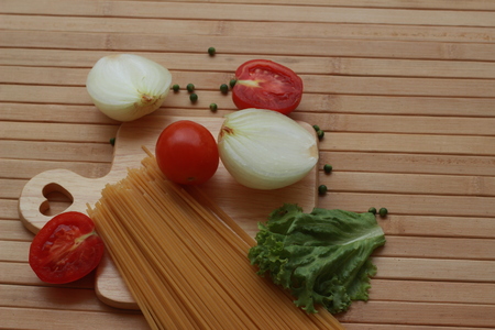 Spaghetti in a white plate and sliced sugar with red ketchupの写真素材