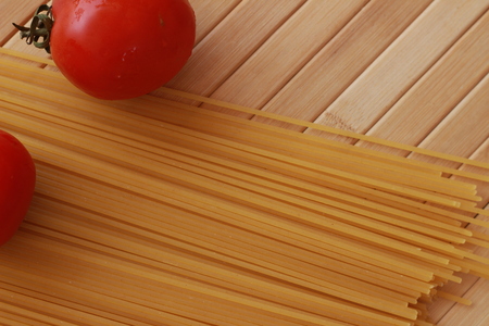Spaghetti in a white plate and sliced sugar with red ketchupの写真素材