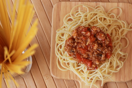 Spaghetti in a white plate and sliced sugar with red ketchupの写真素材