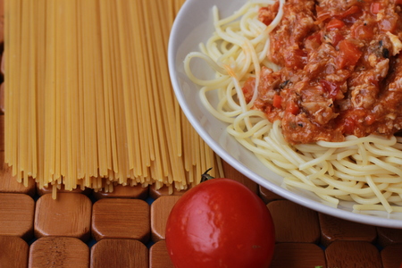 Spaghetti in a white plate and sliced sugar with red ketchupの写真素材