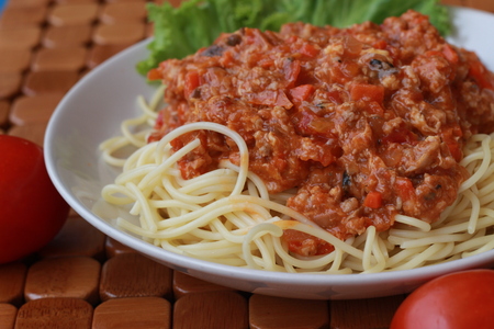 Spaghetti in a white plate and sliced sugar with red ketchupの写真素材