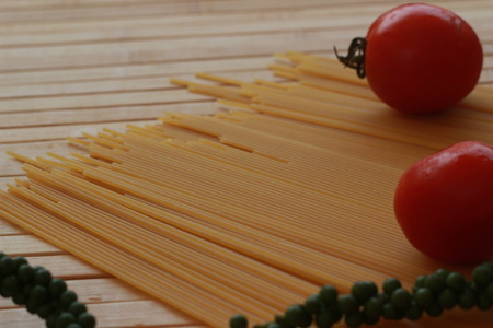 Spaghetti in a white plate and sliced sugar with red ketchupの写真素材