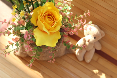 Yellow roses are arranged in bouquets on a brown backgroundの写真素材